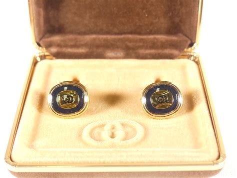 Boutons de manchette GUCCI en métal .